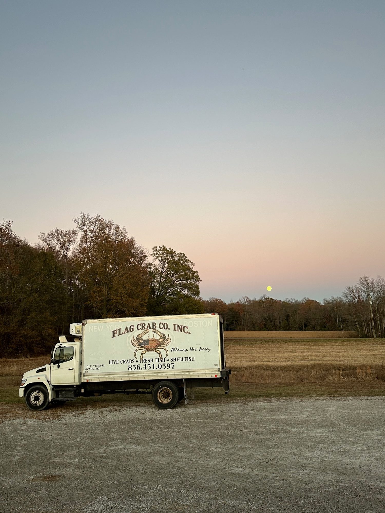 Flag Crab truck at dusk, New York and Boston on the box